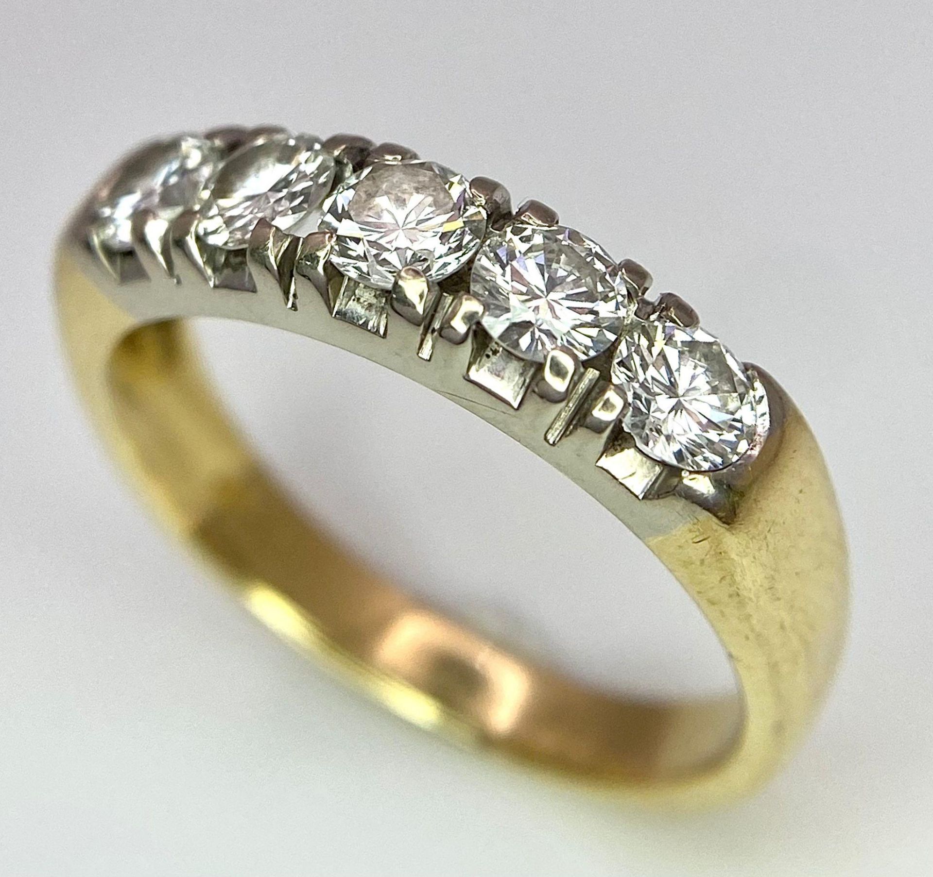 An 18K Yellow Gold Five Stone Diamond Ring. 0.85ctw of brilliant round cut diamonds. Size L. 3.6g