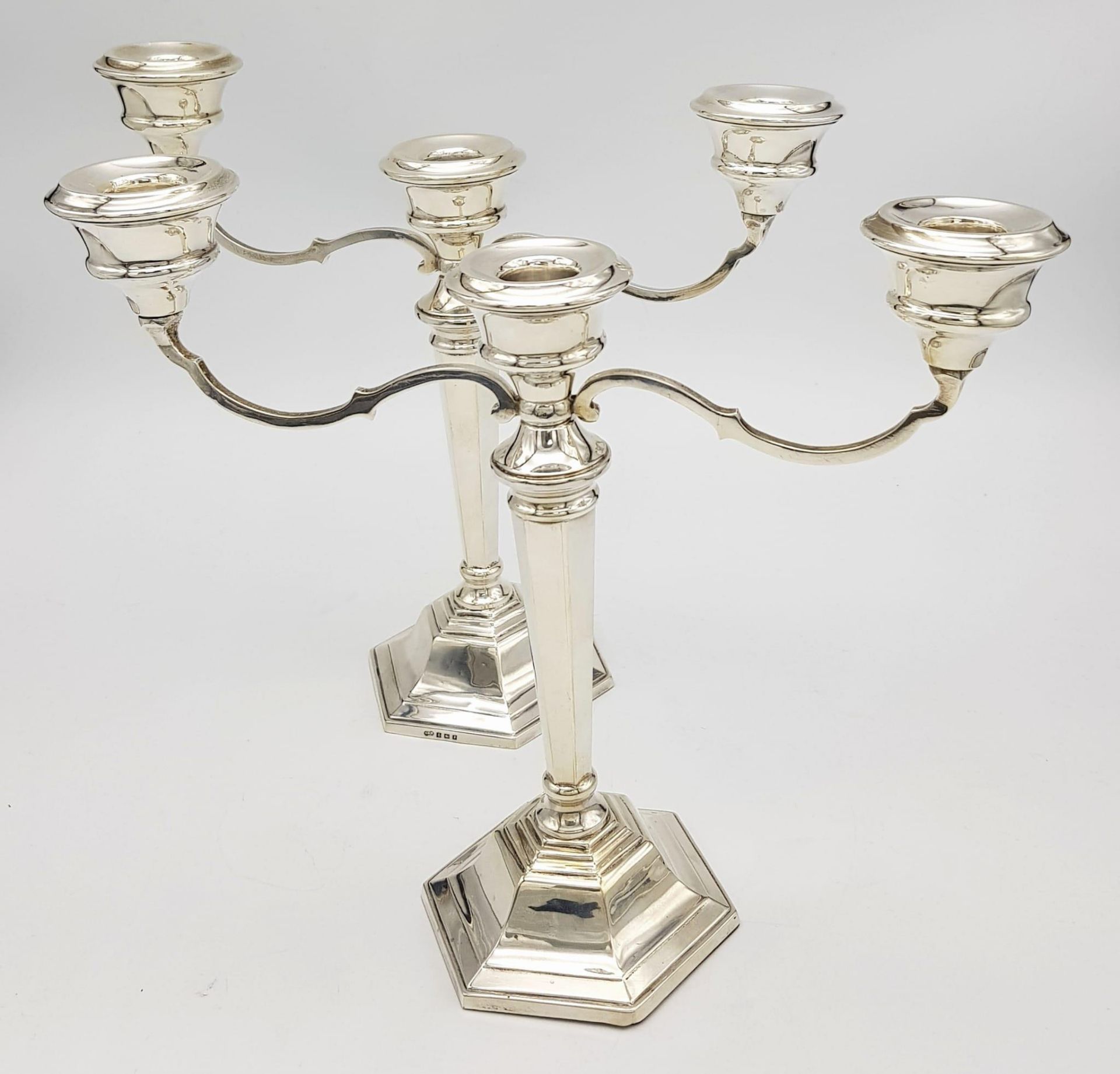A PAIR OF SILVER CANDELABRA EACH HOLDING 3 CANDLES IN CLASSIC STYLE AND HALLMARKED IN BIRMINGHAM