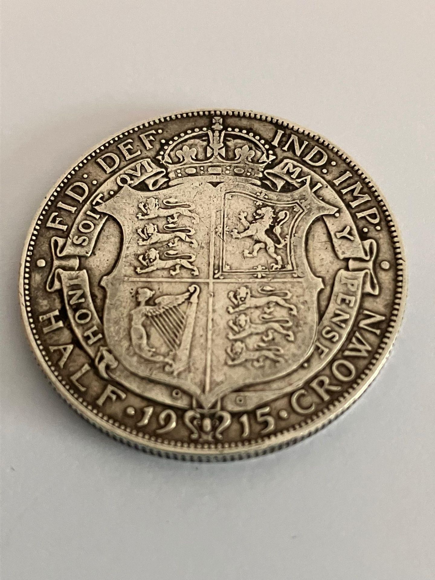 1915 SILVER HALF CROWN. Very fine condition, extra fine condition if Kings blemishes cleared.