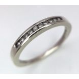 A 9 K white gold ring with a diamond band, size: J, weight: 1.3 g.