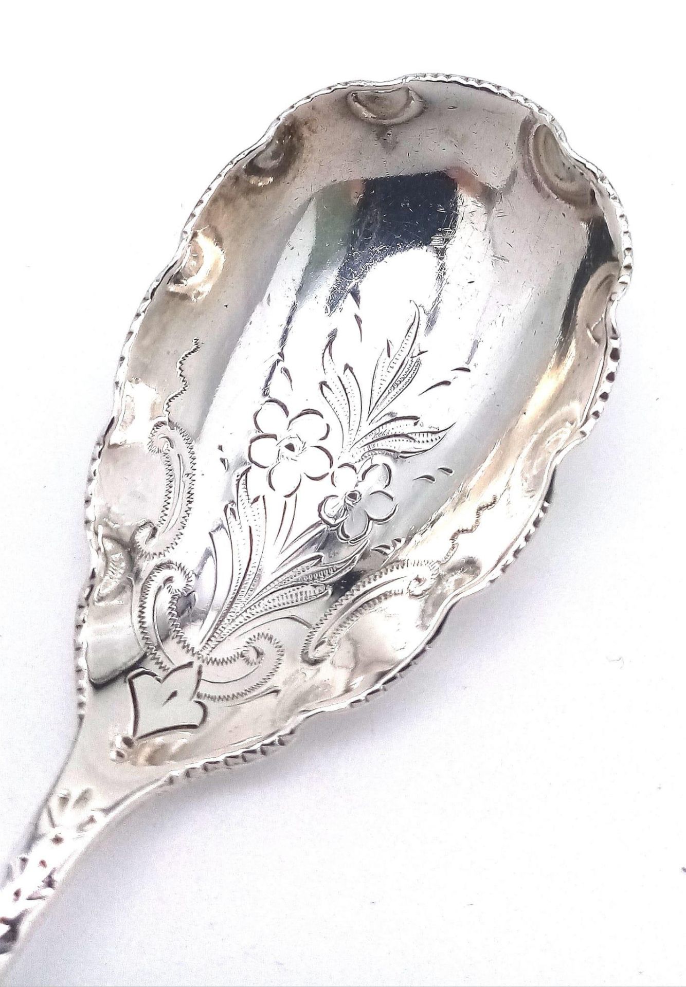 An antique sterling silver dessert spoon with fabulous floral motif engravings on bowl and handle. - Image 4 of 5