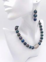 A glamorous Tahitian, black pearl necklace and earrings set highlighted with cubic zirconia. Large