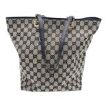 A Gucci GG Brown and Black Monogram Tote Bag. Canvas exterior with leather trim and base, two