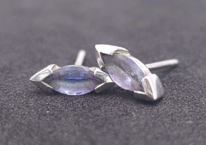 A Pair of 9K White Gold (tested) and Tanzanite Earrings. No backs. 1.1g total weight.