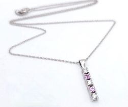 An 18 K white gold drop pendant with diamonds and pink sapphires (rubies) on an 18 K white gold