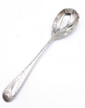 An antique sterling silver dessert spoon with fabulous floral motif engravings on bowl and handle.