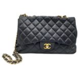 A Chanel Black Caviar Classic Single Flap Bag. Quilted pebbled leather exterior with gold-toned