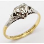 A Vintage 18K Yellow Gold and Platinum Diamond Ring. Round cut diamond in a heart setting. Size O.