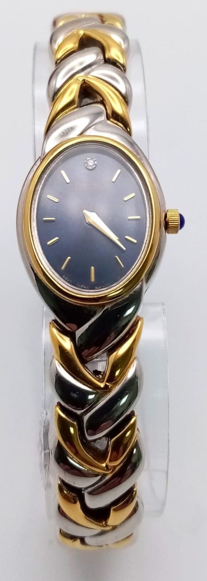 A Seiko Quartz Ladies Watch. Two tone strap and case - 19cm. Blue dial. In good condition and - Bild 2 aus 7
