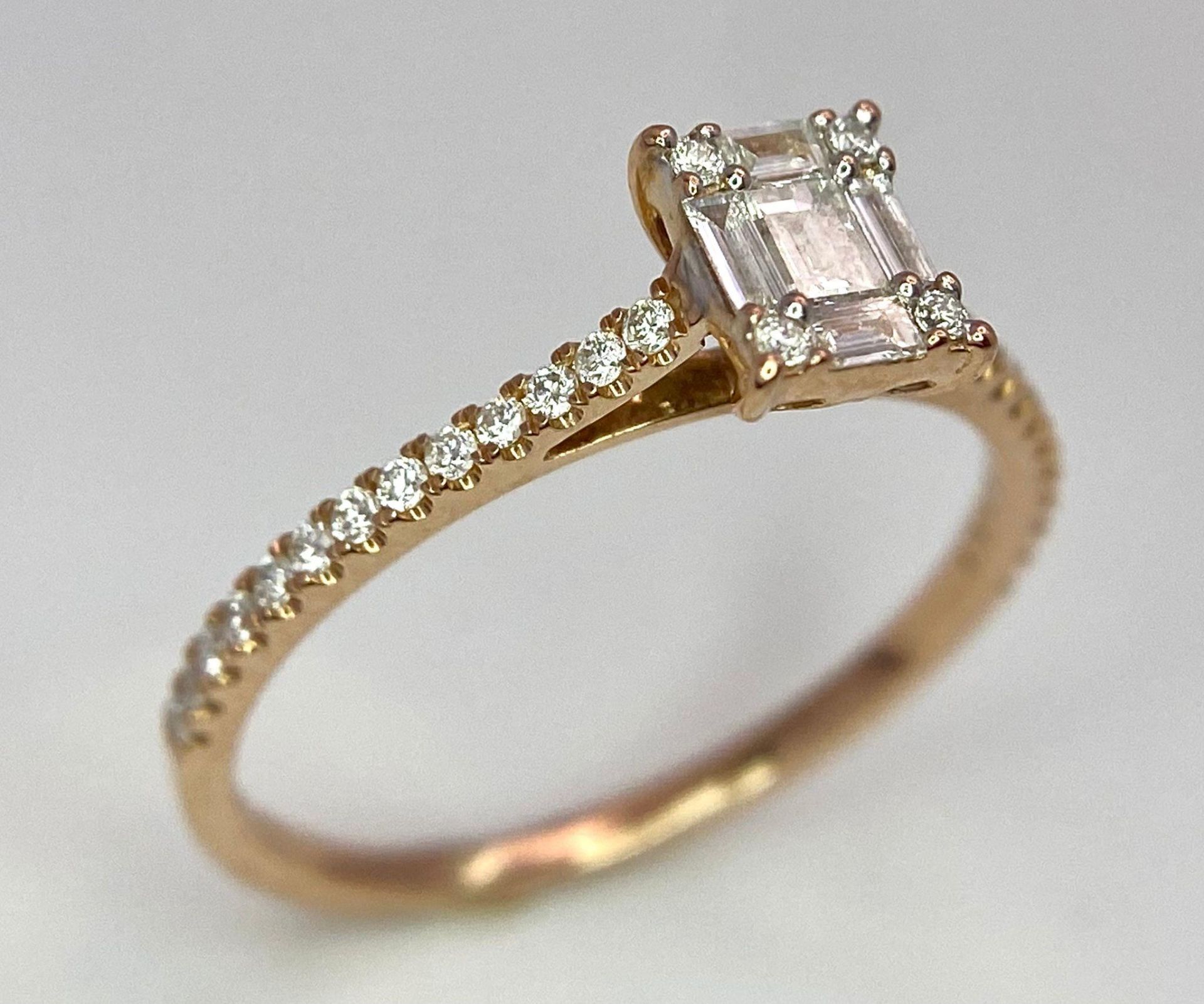 An 18 K rose gold ring with a square emerald cut diamond and more round cut diamonds on the - Image 3 of 8