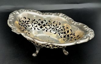 A vintage sterling silver bonbon dish with scrolled feet and pierced floral patterns. Total weight