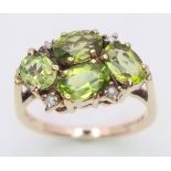 A vintage 9 K yellow gold ring with four oval cut peridots and seed pearls, size: K1/2, weight: 3 g.