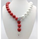 A Contrasting South Sea Pearl Shell Large Bead Necklace. Vibrant red and white beads with white
