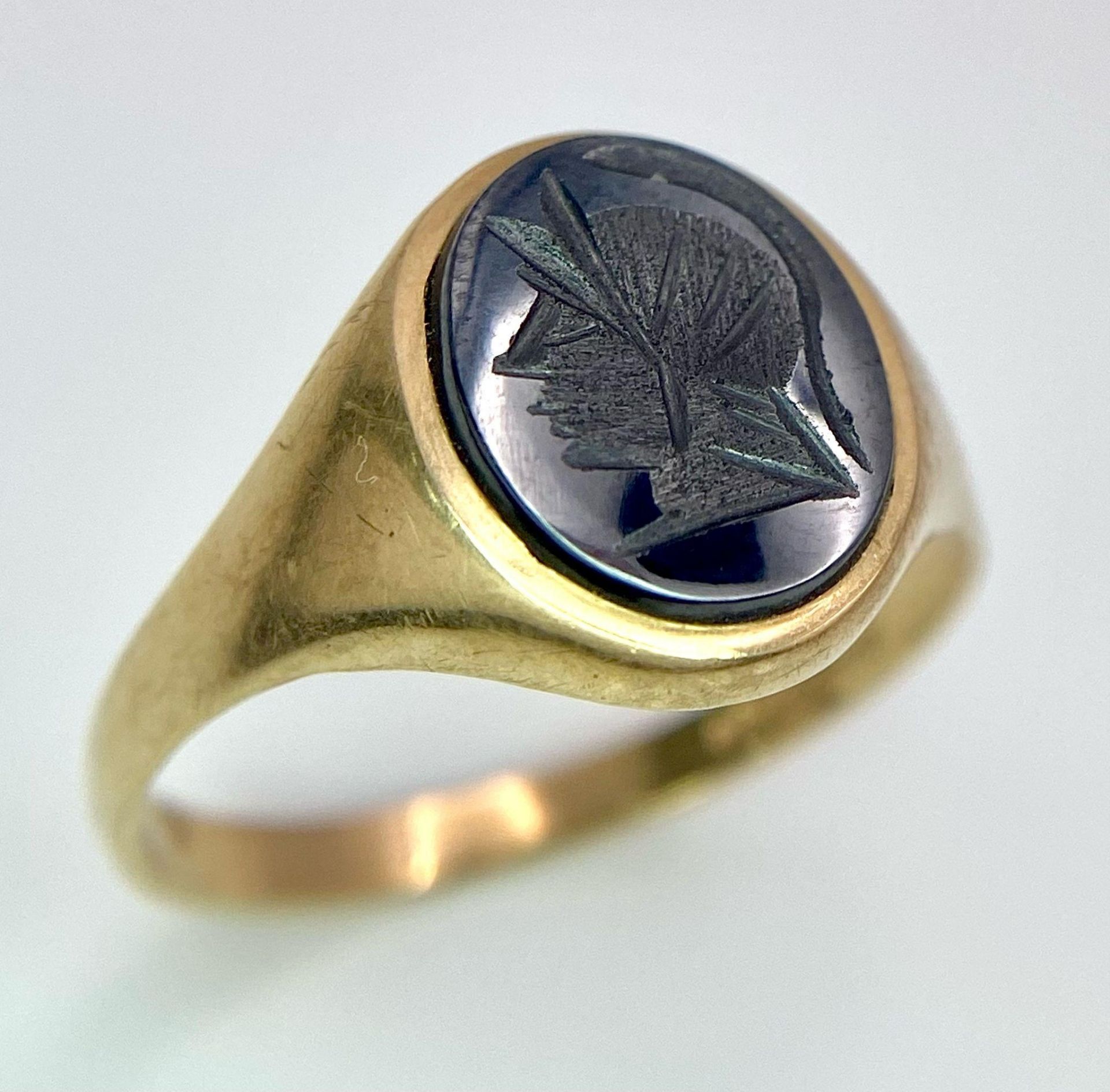 A Vintage 9K Yellow Gold Onyx Signet Ring. Carved centurion decoration. Size T. 3g total weight.
