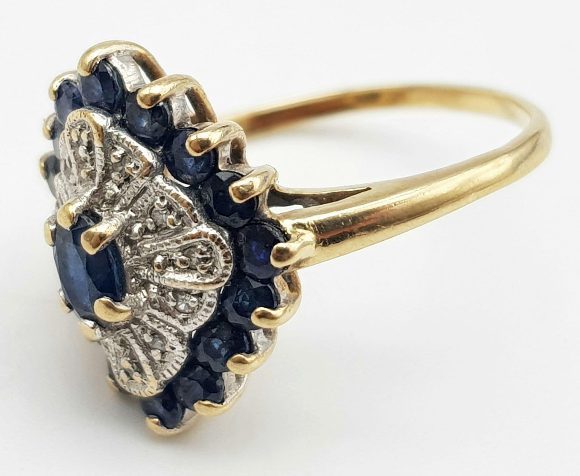 A 9K Yellow Gold Diamond and Sapphire Cluster Ring. Size O. 3.3g total weight. - Image 3 of 4