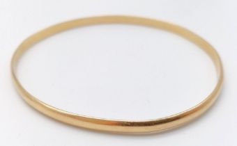 A 9K Yellow Gold (tested) Large Bangle. 7cm inner diameter. 13.05g weight.