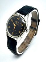 A Vintage Benrus Nobility Self-Winding Gents Watch. Black leather strap. Stainless steel case -
