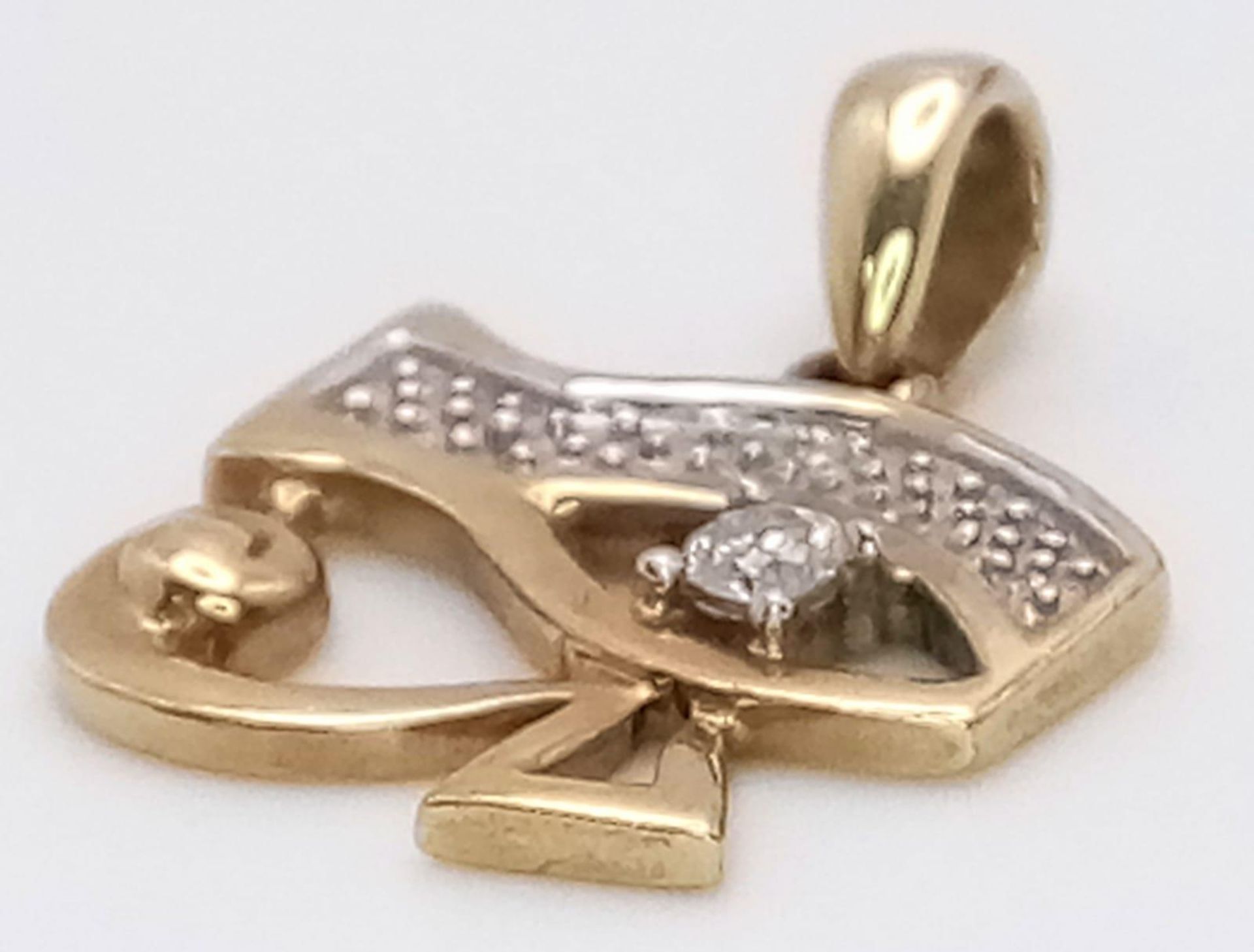 A 9K Yellow Gold and Diamond Eye of Horus Pendant. 2cm. 1.35g total weight.