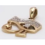 A 9K Yellow Gold and Diamond Eye of Horus Pendant. 2cm. 1.35g total weight.