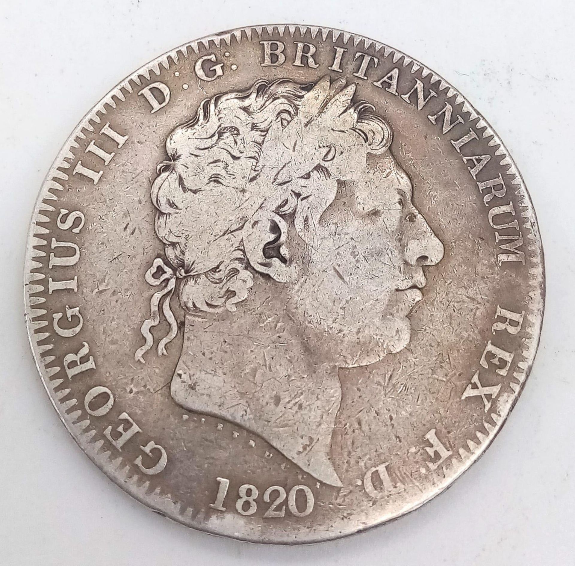 A GEORGE III SILVER CROWN 1820 WITH GEORGE SLAYING THE DRAGON ON THE REVERSE SIDE .