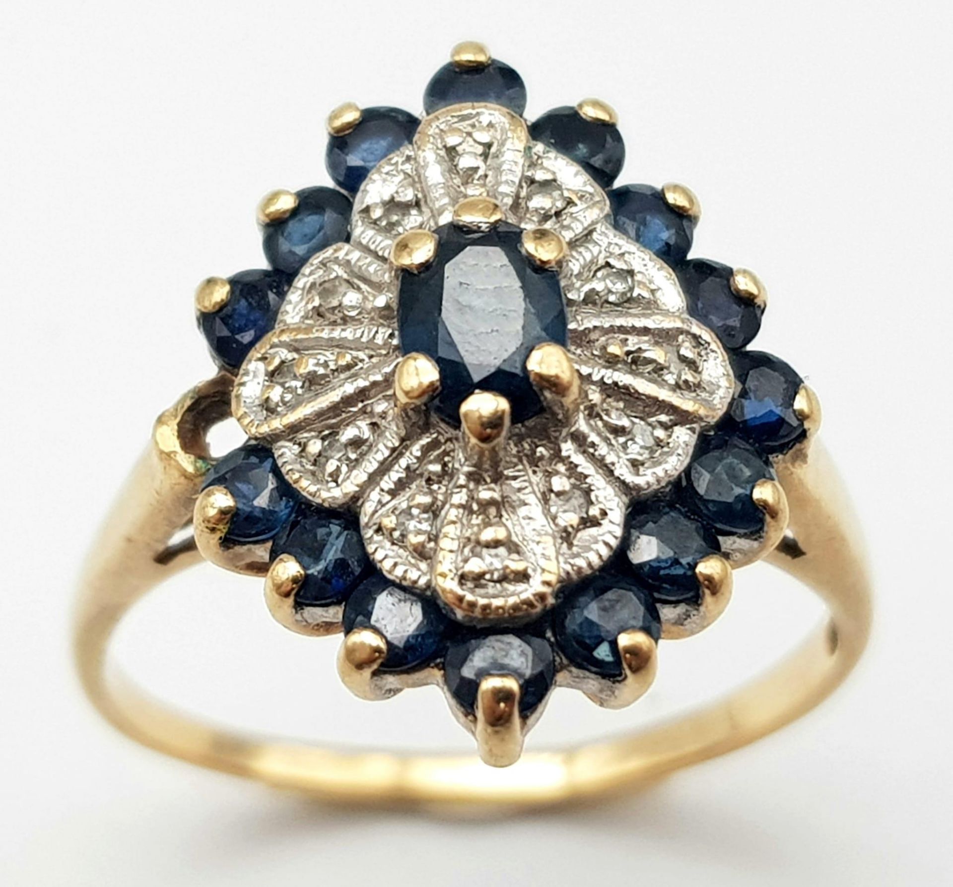 A 9K Yellow Gold Diamond and Sapphire Cluster Ring. Size O. 3.3g total weight. - Image 2 of 4