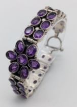An Amethyst Tennis Bracelet set in 925 Sterling silver. Two rows of oval cut amethysts meet a