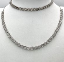 A White Gold Diamond Necklace and Tennis Bracelet. Necklace - 10k white gold with slightly graduated