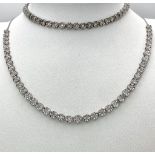 A White Gold Diamond Necklace and Tennis Bracelet. Necklace - 10k white gold with slightly graduated
