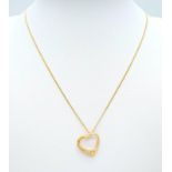 An 18K Yellow Gold Diamond Set Open Heart Pendant on an 18K Yellow Gold Disappearing Necklace.