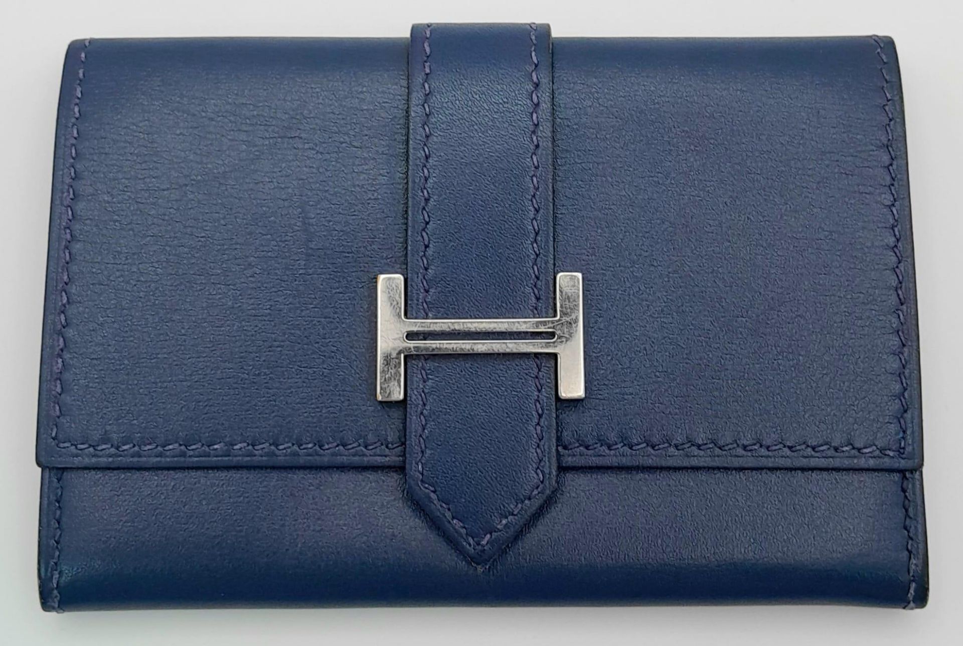 A Small Blue Leather Hermes Ladies Wallet. Flap design with Letter H branding. In good condition but