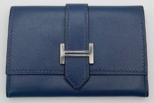 A Small Blue Leather Hermes Ladies Wallet. Flap design with Letter H branding. In good condition but