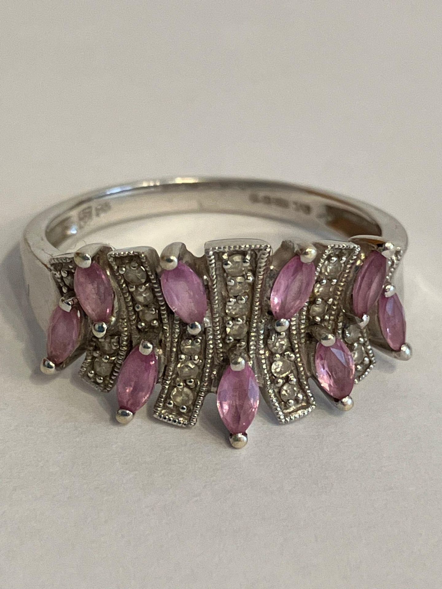 An absolutely exquisite 9 carat WHITE GOLD RING set with PINK SAPPHIRES and DIAMONDS. 3.46 grams.