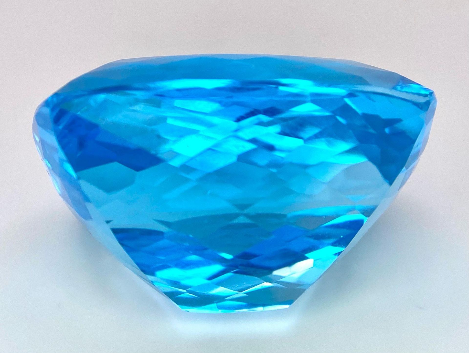 A Huge 142ct London Blue Topaz Natural Gemstone. Rectangular cushion cut. 33mm x 28mm. No visible - Image 4 of 7