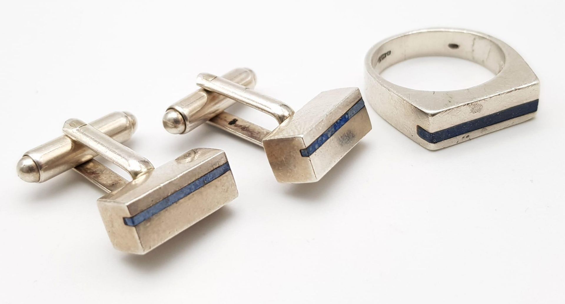 A Silver Ring and Cufflinks with Inlaid Lapis Decoration. Ring -size N. 23g total weight.