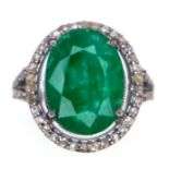 An Emerald Ring with a Halo of Diamonds on 925 Silver. 7.55ct emerald, 0.67ctw diamonds. Size N, 4.