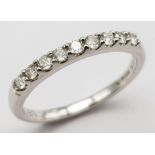 An 18K White Gold and Diamond Half-Eternity Ring. 0.20ctw. Comes with a certificate. Size K. 2.2g