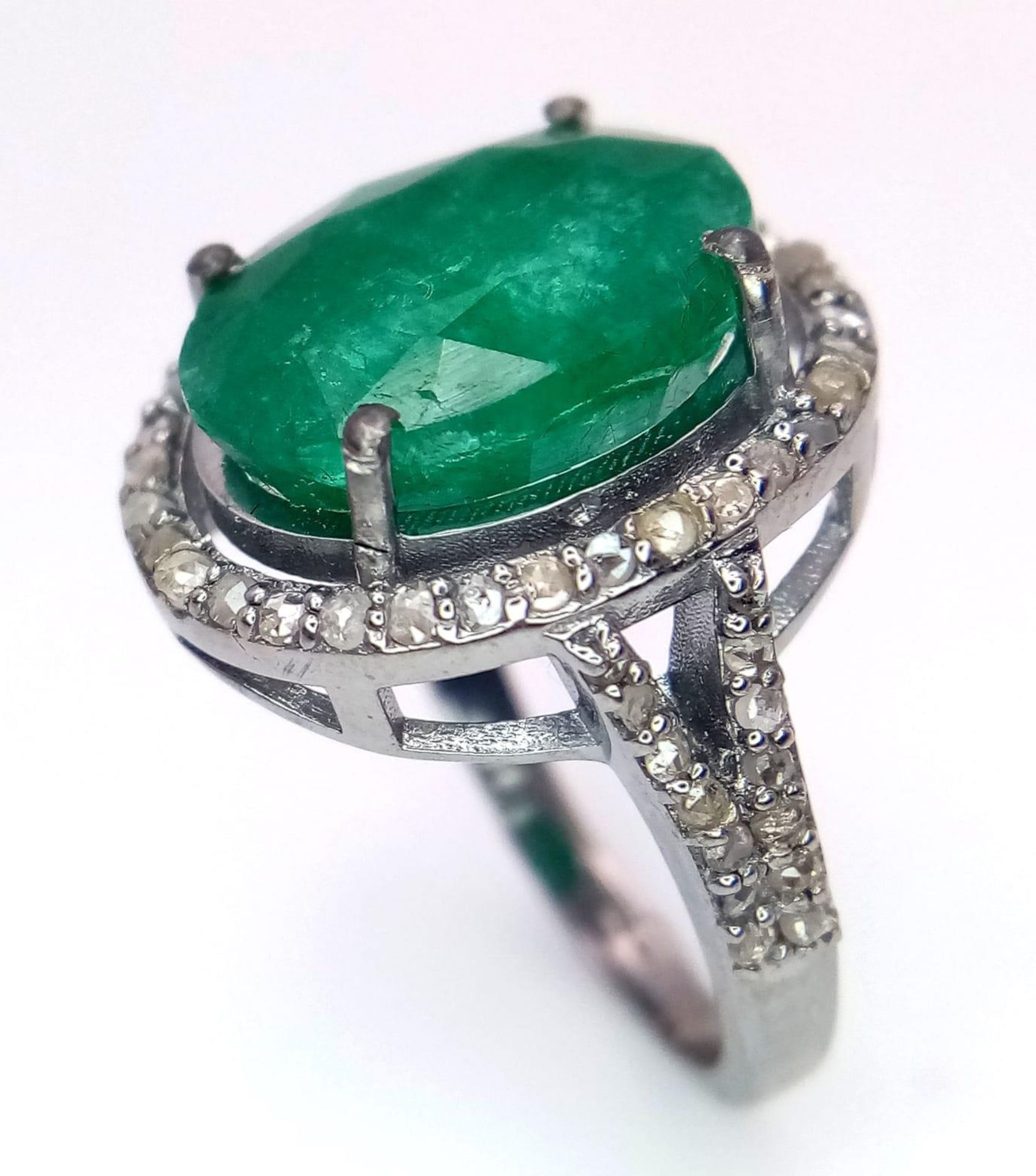 An Emerald Ring with a Halo of Diamonds on 925 Silver. 7.55ct emerald, 0.67ctw diamonds. Size N, 4. - Image 2 of 6