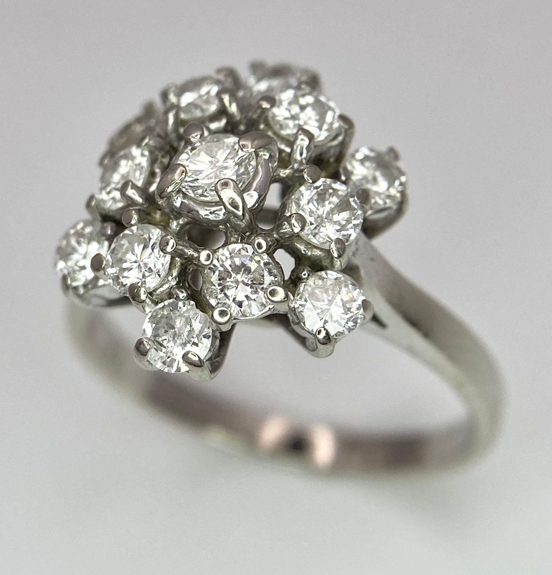 An 18 K white gold ring with a cluster of diamonds (1.10 carats), size: K, weight: 3.6 g.