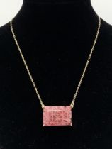 A Carved African Ruby Pendant on a Gold Plated 925 Silver Necklace. Rectangular step cut. 52.20ct W-