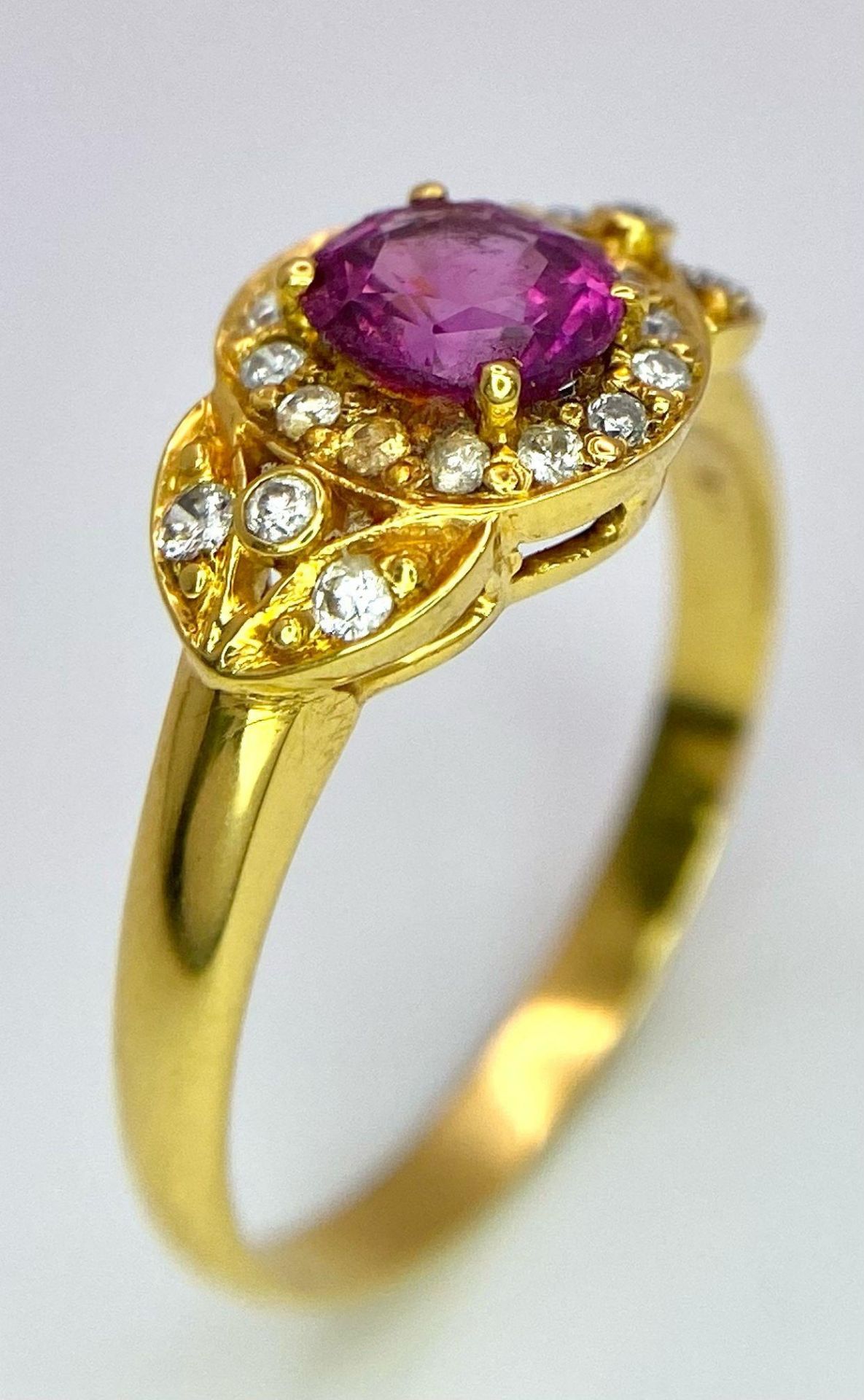 An 18K Yellow Gold Pink Sapphire and Diamond Ring. Central oval sapphire with diamond halo and - Image 4 of 12