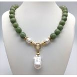 A Keisha Baroque Pearl Pendant on a Pale Green Jade Necklace. White stone accents and gilded
