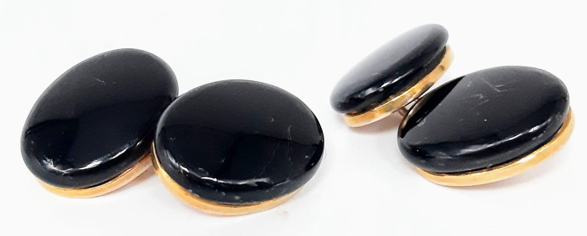 A Pair of Victorian English memorial onyx and gold oval cuff links - marked 10K gold. 9.71g total