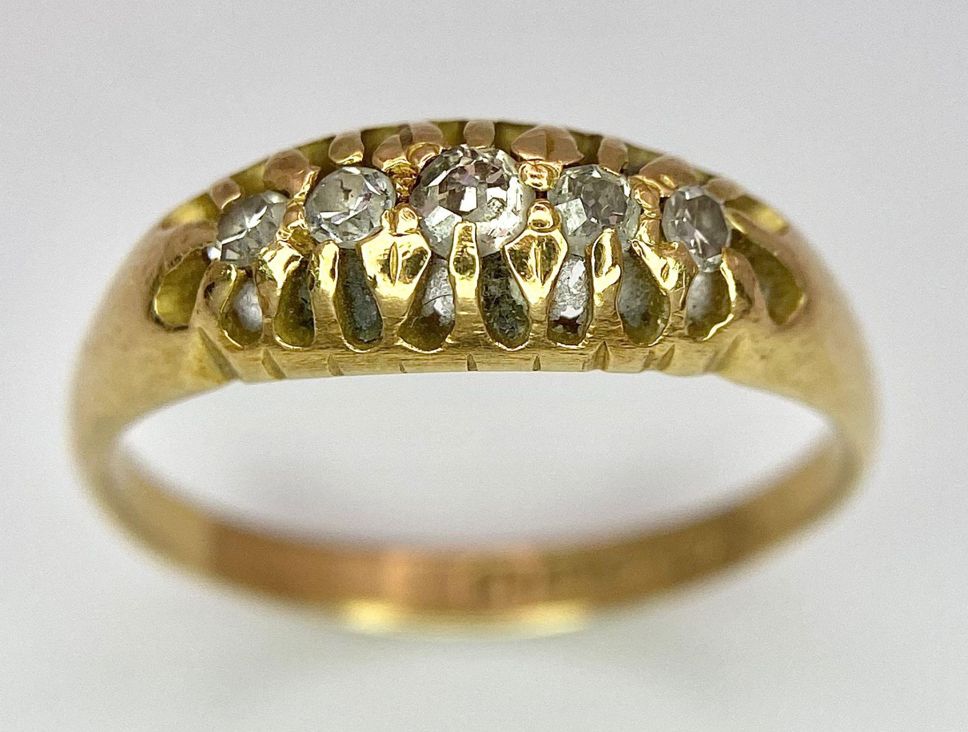 An 18 K yellow gold ring with a band of five diamonds, size: O, weight: 3.2 g. - Image 2 of 7