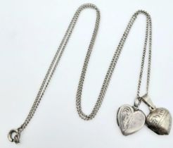 A vintage sterling silver necklace with 2 silver heart locket pendants. Total weight 5.6G. Total