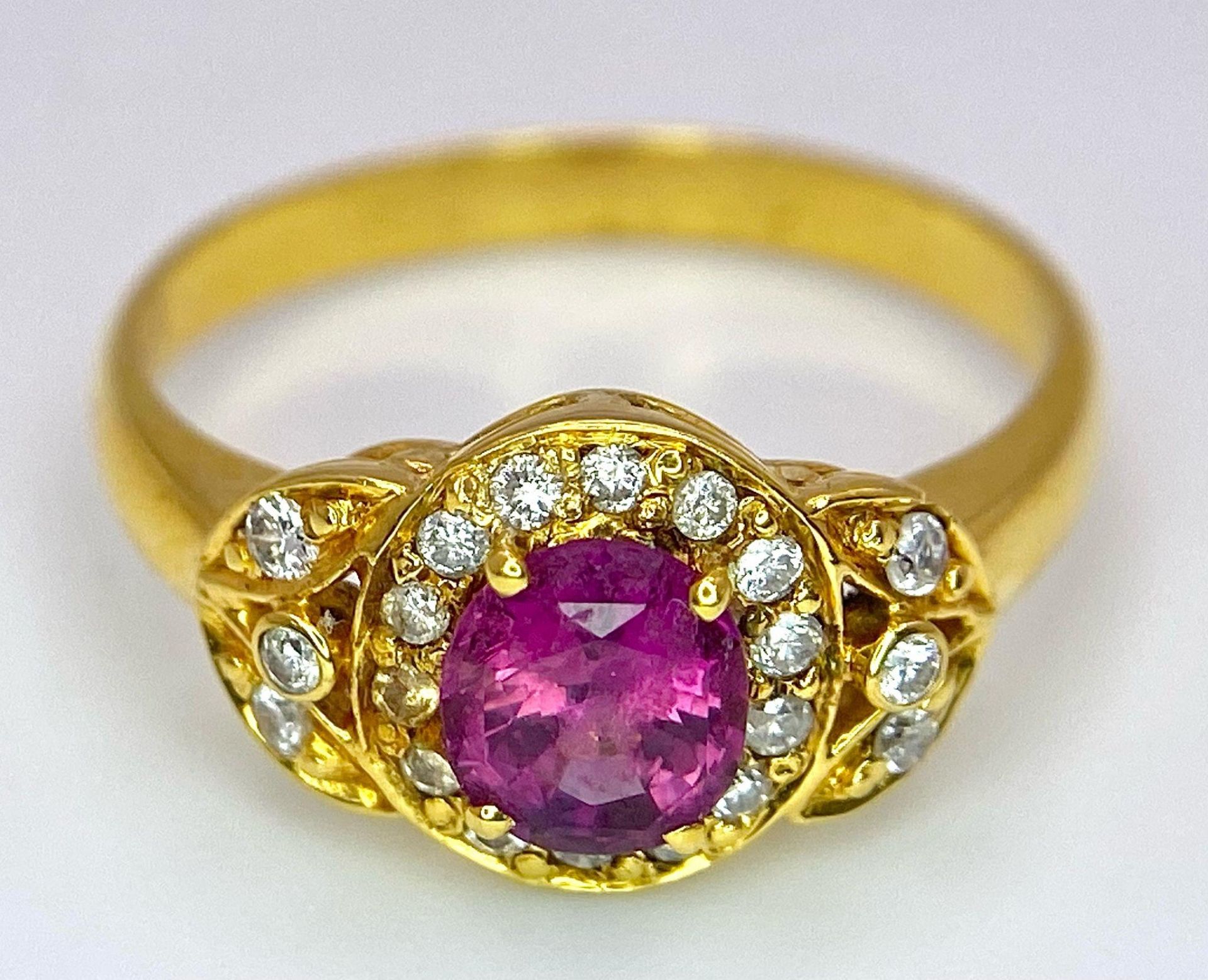 An 18K Yellow Gold Pink Sapphire and Diamond Ring. Central oval sapphire with diamond halo and - Image 9 of 12