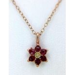 A 9K Yellow Gold Ruby and Diamond Small Floral Pendant on a 9K Yellow Gold Disappearing Necklace.