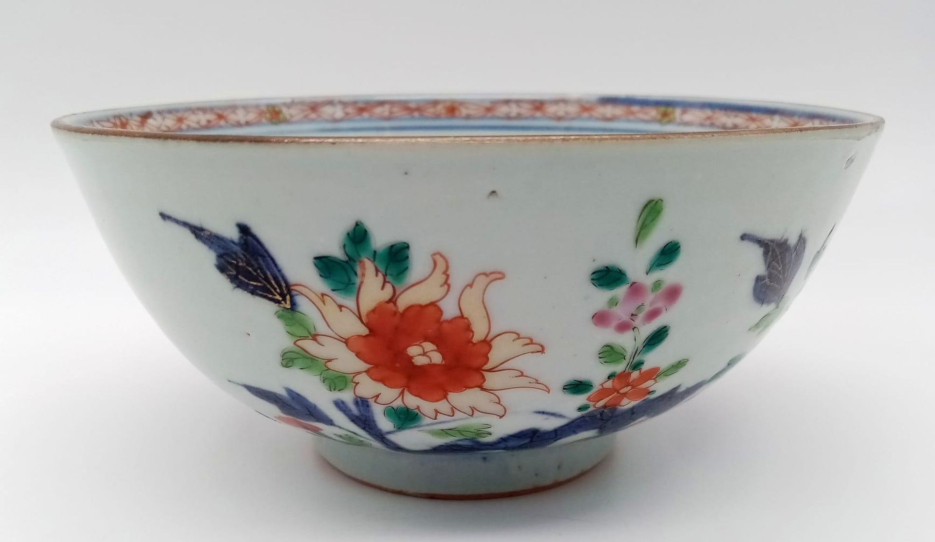 AN 18TH CENTURY CHINESE BOWL WITH EXQUISITE DECORATION OF PEONIES AND GREEN LEAVES . AS ORIGINAL