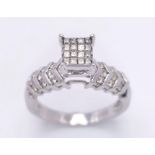 A 14K White Gold Diamond Ring. Miniature square cut diamonds in a raised setting with round cut