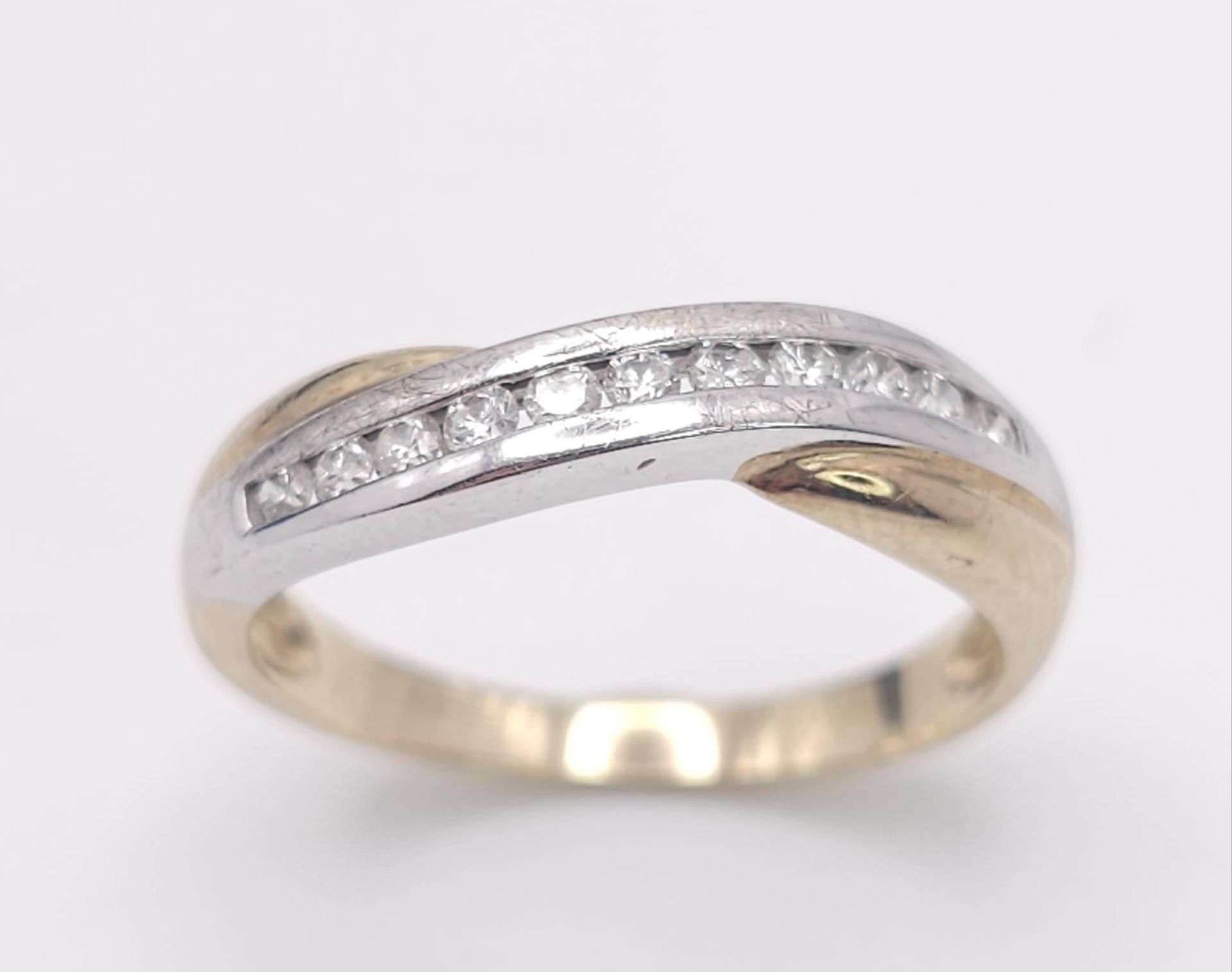 A 9K Yellow Gold and Diamond Half-Eternity Ring. 0.22ctw. 2.3g total weight. Size P.