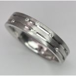 An 18K White Gold Two-Row Diamond Eternity Ring. Size O. 4.9g total weight.